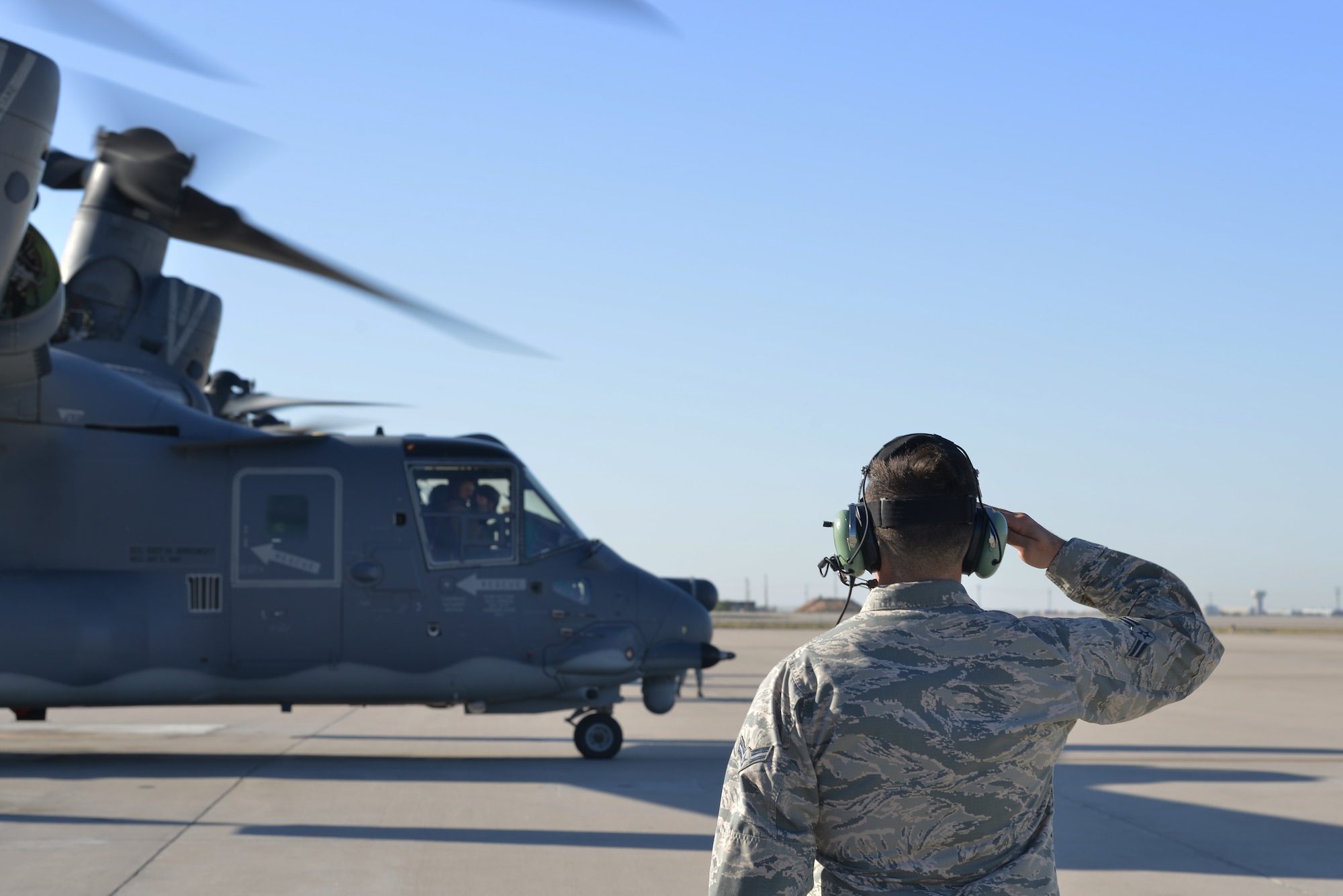 U.S. Air Force Airman 1st Class Ethan McCausland, 71st Aircraft Maintenance Unit CV-22 Osprey crew chief, salutes the aircrew of a CV-22 Osprey, at Kirtland Air Force Base, N.M., Oct. 7, 2019. Over the last fiscal year, the AMU hit their 1,500 flight hour goal for the CV-22 Osprey. The mission of the 71st AMU is to provide mission ready CV-22 Ospreys for the 71st Special Operations Squadron. (U.S. Air Force photo by Staff Sgt. Dylan Nuckolls)