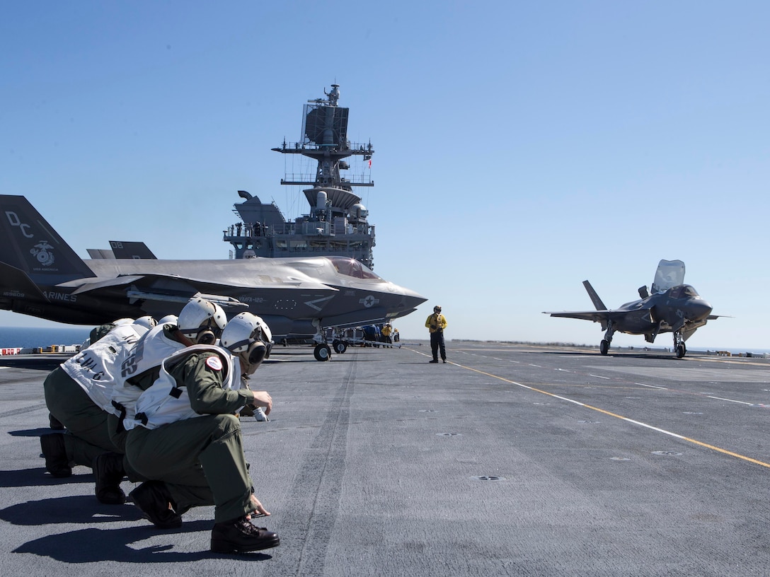 Senior leadership from 3rd Marine Aircraft Wing and the USS America brace for the blast as an F-35B Lightning II launches off of the amphibious assault ship USS America (LHA 6) in the eastern Pacific, Oct. 6, 2019. Integrating 3rd MAW’s combat power and capabilities while conducting realistic training is essential to generate readiness and lethality in our units. (U.S. Marine Corps photo by Sgt. Charles Plouffe)