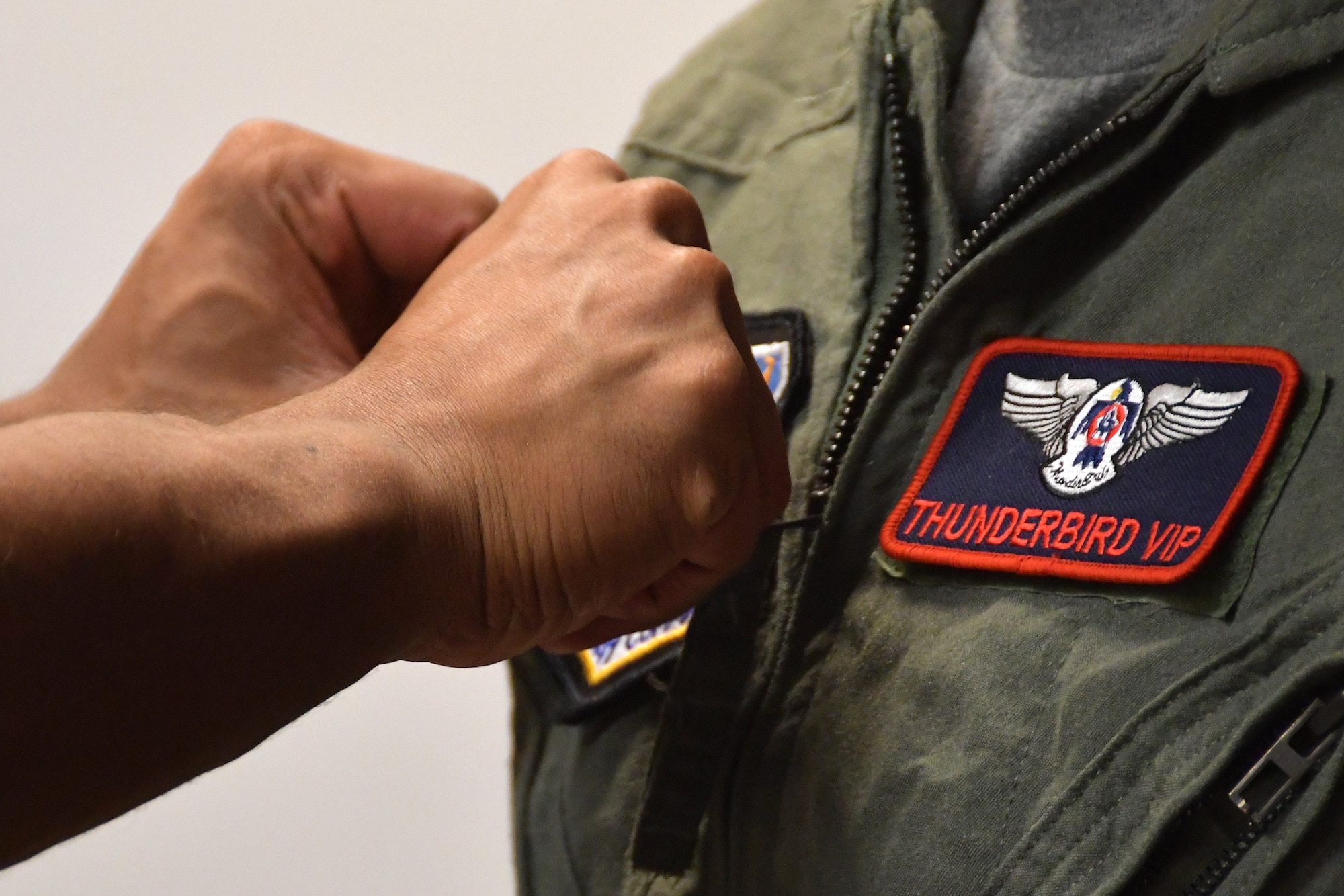 An Airman puts a patch on the flight suit of Tracey Pendley, an Atlanta Public Schools fourth grade teacher, at Dobbins Air Reserve Base, Ga. on Oct. 11, 2019. In addition to being named Georgia’s Teacher of the Year, Tracey was also nominated as a Hometown Hero, a program which allows exceptional community members to be nominated for a familiarization flight in a Thunderbirds jet, an F-16 Fighting Falcon. (U.S. Air Force photo/Airman Kendra A. Ransum)