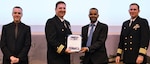 IMAGE: Mulugeta Tesfaye receives his certificate of achievement from Naval Surface Warfare Center Dahlgren Division (NSWCDD) Dam Neck Activity Commanding Officer Cmdr. Joseph Oravec at the 2019 NSWCDD academic recognition ceremony held at the University of Mary Washington Dahlgren campus. Tesfaye was congratulated at the event for completing a master’s degree in cyber engineering from Morgan State University by Oravec, NSWCDD Commanding Officer Capt. Casey Plew, right, and NSWCDD Deputy Technical Director Darren Barnes.