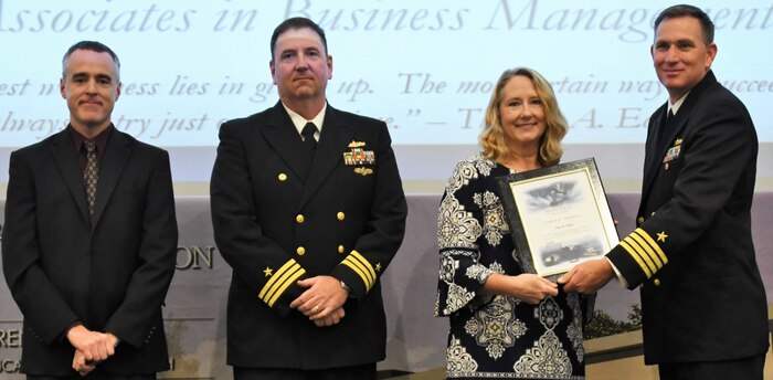 IMAGE: Tina Willis receives her certificate of achievement from Naval Surface Warfare Center Dahlgren Division (NSWCDD) Commanding Officer Capt. Casey Plew at the 2019 NSWCDD academic recognition ceremony held at the University of Mary Washington Dahlgren campus. Willis was congratulated at the event for completing an associates degree in business management from Rappahannock Community College by Plew, NSWCDD Dam Neck Activity Commanding Officer Cmdr. Joseph Oravec and NSWCDD Deputy Technical Director Darren Barnes.