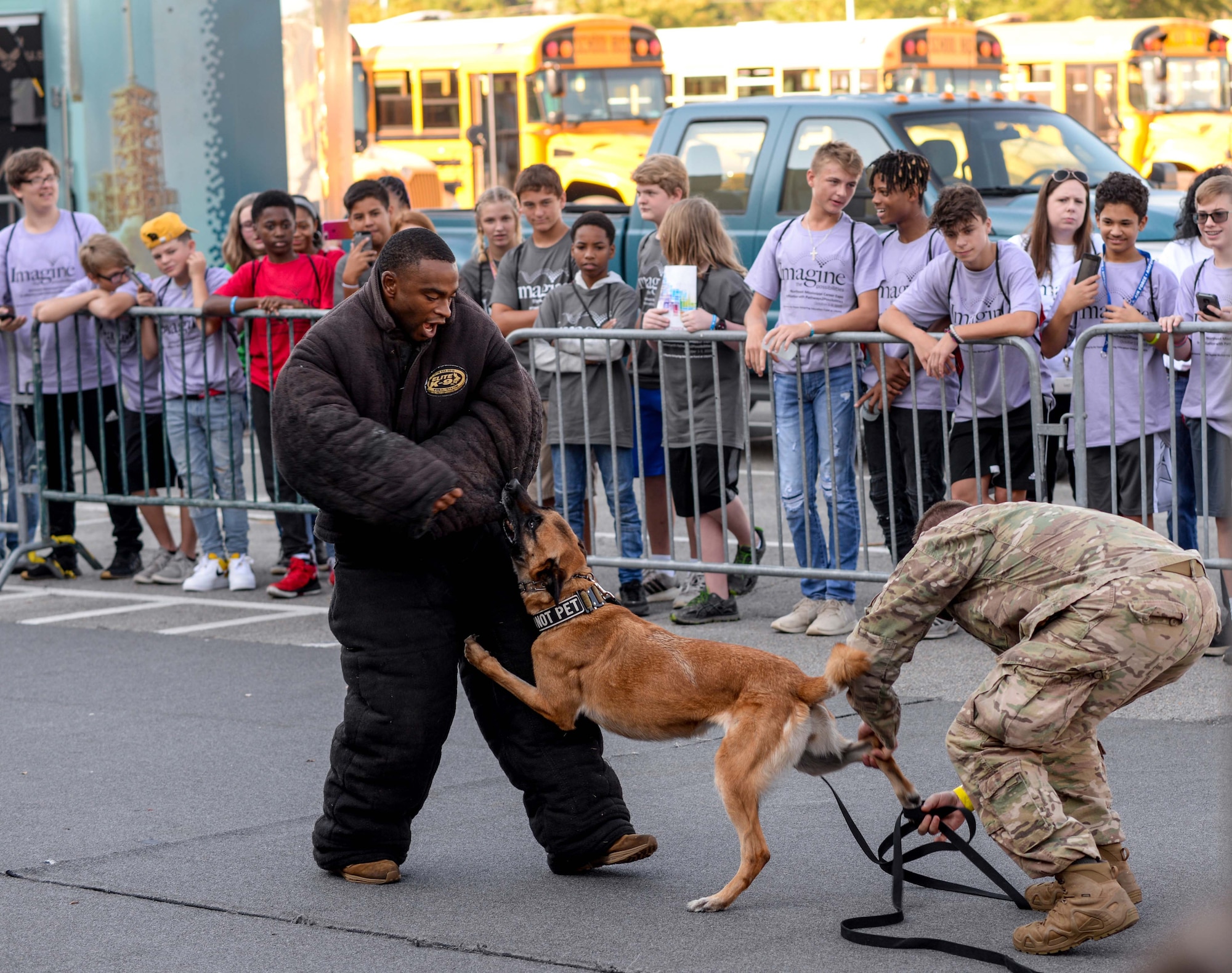 Two Airmen from the 14th Security Forces Squadron at Columbus Air Force Base, Miss., demonstrate the ability of a military working dog at the Imagine the Possibilities Career Expo Oct. 1, 2019, at the BancorpSouth Arena in Tupelo. A SFS member must complete 18 months of service before they can train to become a MWD handler. (U.S. Air Force photo by Airman Davis Donaldson)