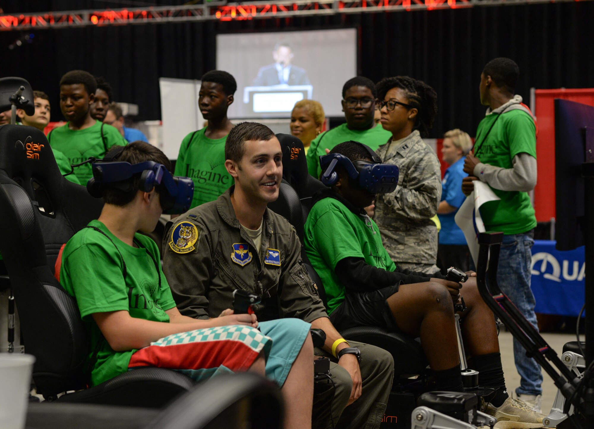 First Lt. John Schoettelkotte, a 37th Flying Training Squadron instructor pilot at Columbus Air Force Base, Miss., helps a student operate virtual reality simulator at a convention in Tupelo, Miss., October 1, 2019. Student pilots at Columbus Air Force Base use simulators to train and become comfortable with mechanics before flying an aircraft. (U.S. Air Force photo by Airman Davis Donaldson)