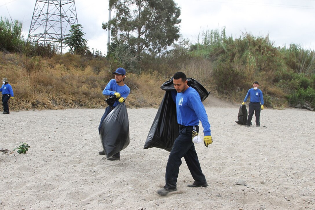 Volunteers with the San Gabriel Valley Conservation Corps crew remove bags of debris during a clean-up event at the Whittier Narrows Dam Nature Center Sept. 28 in South El Monte, California. The U.S. Army Corps of Engineers Los Angeles District, along with Los Angeles County and the Whittier Narrows Nature Center Associates hosted the event as part of National Public Lands Day.