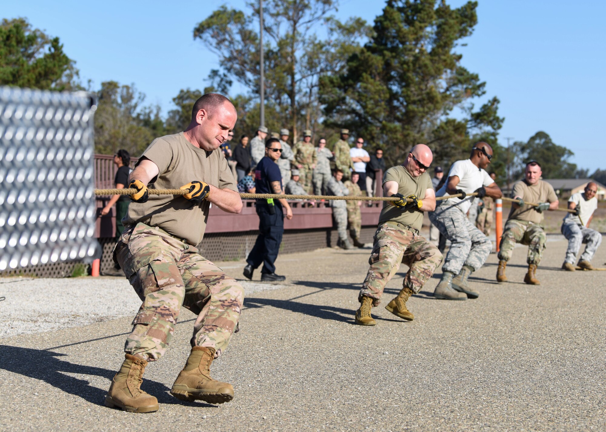 Service members pull a firetruck to begin the 2019 Fire Muster Challenge to commemorate Fire Prevention Week Oct. 10, 2019, at Vandenberg Air Force Base, Calif. Firefighters provide lifesaving public education in an effort to drastically decrease casualties caused by fires. Fire Prevention Week is observed each year during the week of October 9th to commemorate the Great Chicago Fire on October 8, 1871. (U.S. Air Force photo by Airman 1st Class Aubree Milks)