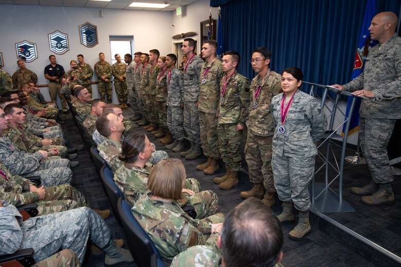 Airman Leadership School class graduates stand to be recognized during the ALS graduation at Peterson Air Force Base, October 10, 2019. Class 19-7 graduates were recognized for their performance during the 24 days of required training. (U.S. Air Force photo by Katie Calvert)