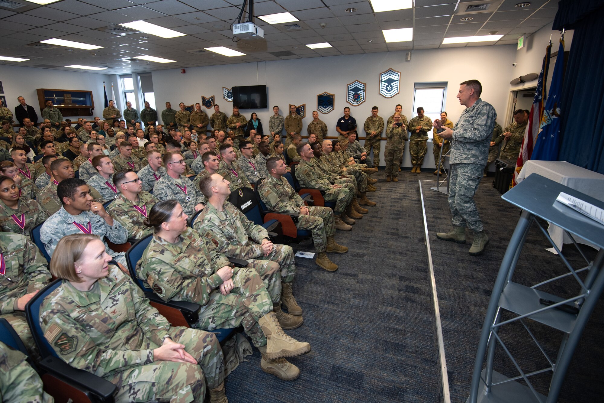 Col. James Smith, 50th Space Wing commander congratulates Airmen on their accomplishments during the Airmen Leadership School graduation at Peterson Air Force Base, Colorado, Oct. 10, 2019. Forty-six Airmen from Peterson and Schriever Air Force Base, Fort Carson, United States Air Force Academy and Chayenne Mountain Air Force Station graduated in class 19-7. ALS is designed to prepare senior airmen to become supervisors and future leaders. (U.S. Air Force photo by Katie Calvert)