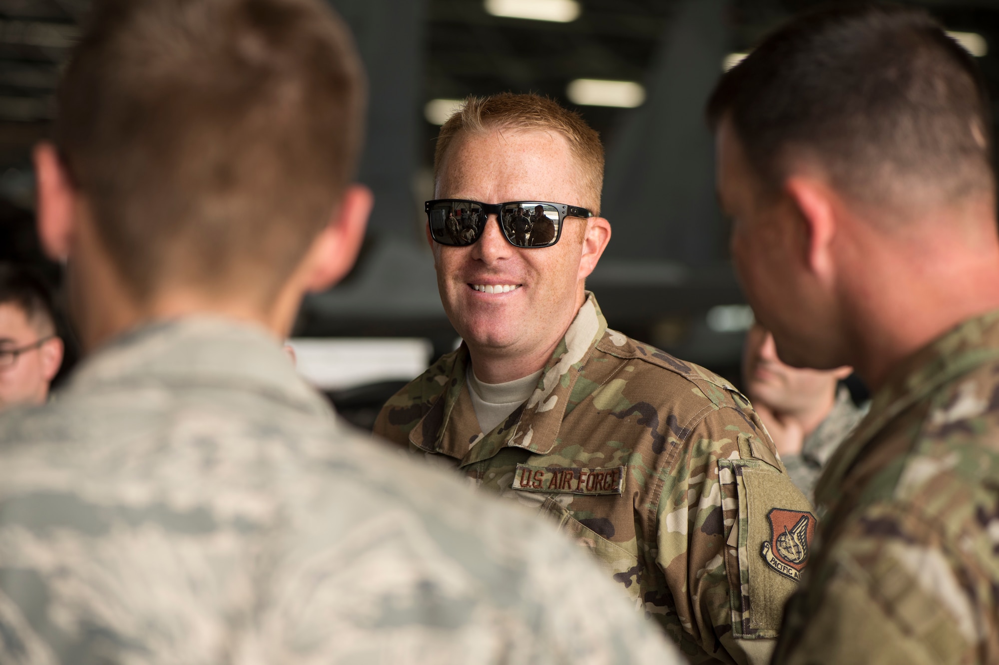 U.S. Air Force Master Sgt. Kyle Dunn, the 13th Aircraft Maintenance Unit F-16 Fighting Falcon production superintendent, smiles while speaking with his fellow Airmen during an aviation training relocation at Komatsu Air Base, Japan, Sept. 30, 2019. Approximately 90 Misawa Airmen and six U.S. Air Force F-16 Fighting Falcons traveled to Komatsu AB in support of facilitating bilateral training sorties while enhancing tactical skillsets, friendships and alliances with their host nation partners. (U.S. Air Force photo by Senior Airman Collette Brooks)