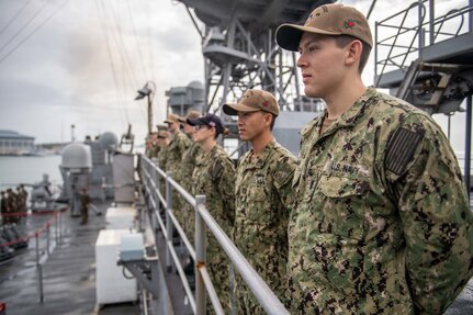 MAURA, Brunei (Oct. 10, 2019) Sailors man the rails as the amphibious dock landing ship USS Harpers Ferry (LSD 49) arrives in Maura, Brunei, for Cooperation Afloat Readiness and Training (CARAT) Brunei. Harpers Ferry and elements of the 11 Marine Expeditionary Unit (MEU) are ashore in Brunei to perform day and night training in an urban environment and to enhance interoperability and partnership between the U.S. and Brunei during CARAT Brunei 2019.