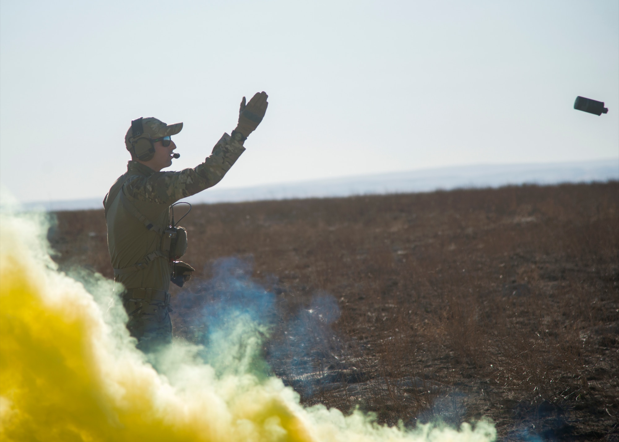Staff Sgt. David Chorpeninng, 366th Fighter Wing survival, evasion, resistance and escape specialist, pops a M-18 smoke grenade Sept. 26, 2019, at Saylor Creek Bombing Range, Idaho.