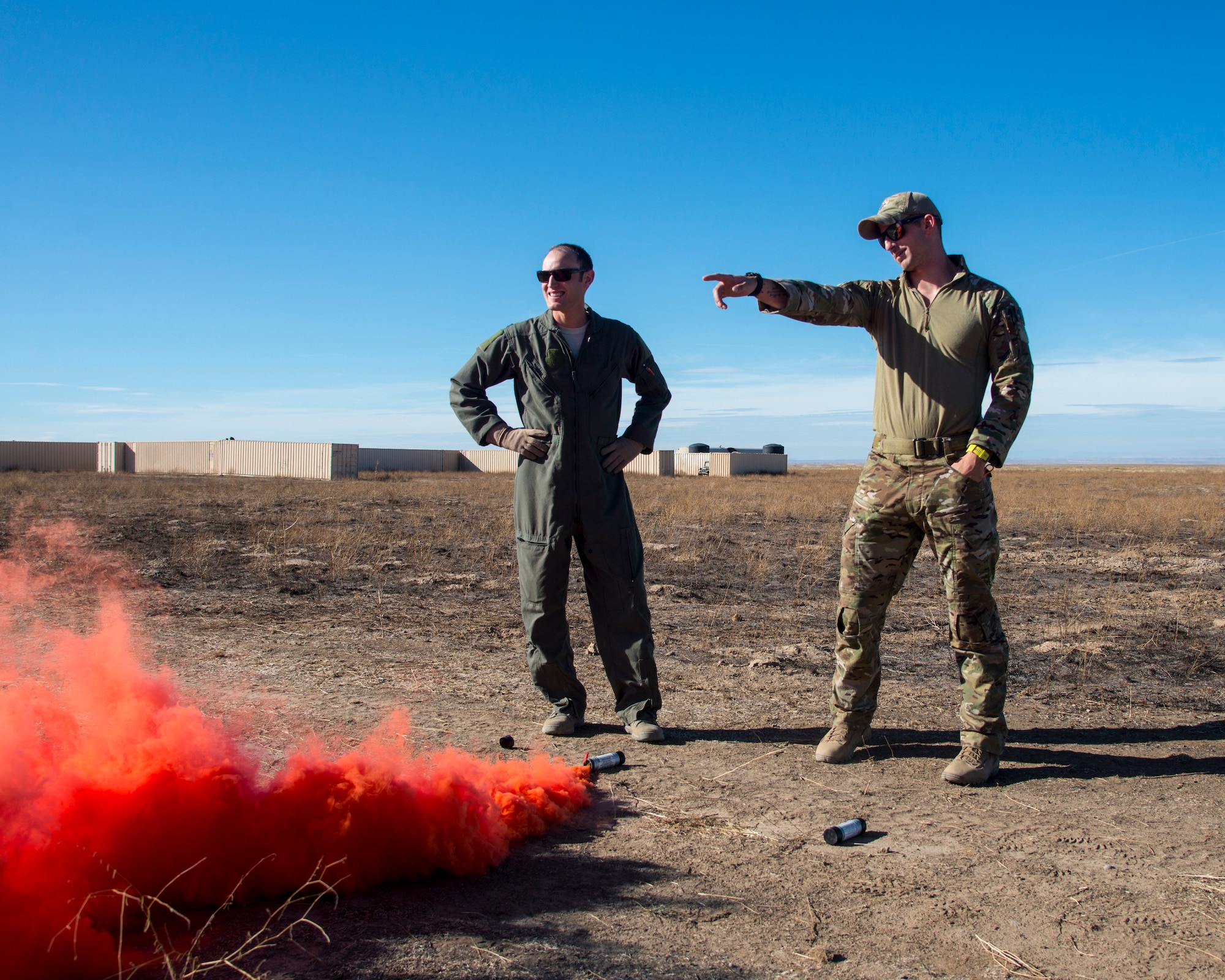 Staff Sgt. David Chorpeninng, 366th Fighter Wing survival, evasion, resistance and escape specialist, explains to Capt. Scott Hatter, 389th Fighter Squadron aircrew how to properly use a MK-124 marine smoke and illumination signal Sept. 26, 2019, at Saylor Creek Bombing Range, Idaho.