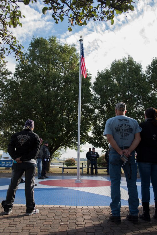 Members of the Ground Zero Flag Team watch as a flag flies at the AMC Museum Oct. 12, 2019, at Dover Air Force Base, Del. The flag was flown at the site of Ground Zero after 9/11 and continues to fly all over the world because of the Ground Zero Flag Team. (U.S. Air Force photo by Airman 1st Class Jonathan Harding)