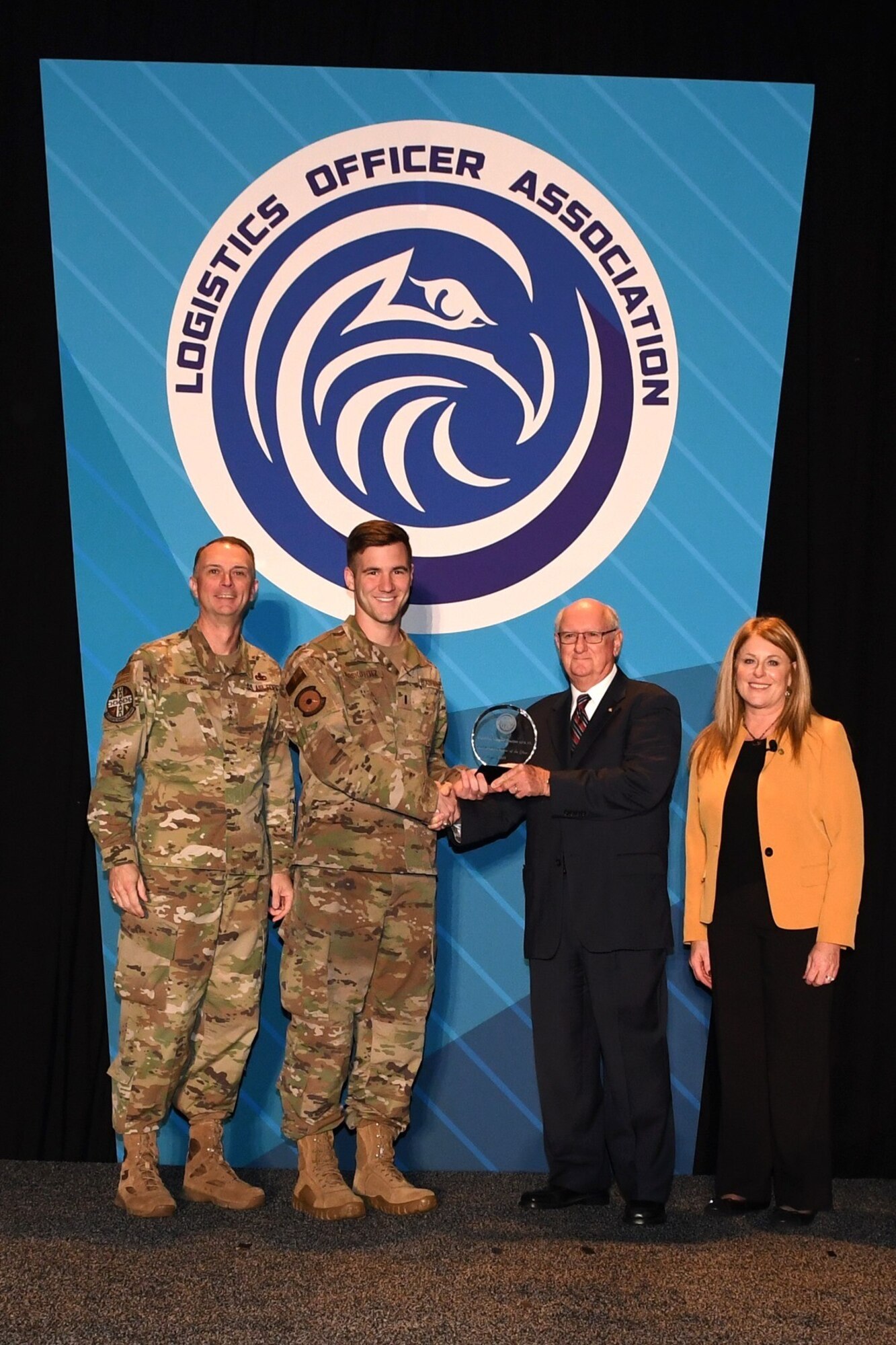 Retired Air Force Col. James Hass presents the MacDill Lightning Chapter the Logistics Officer Association’s (LOA) 2019 Small Chapter of the Year award to Air Force 2nd Lt. Matt Moskowitz, MacDill Air Force Base’s Lightning Chapter vice president assigned to the 6th Logistics Readiness Squadron during the LOA Symposium Oct. 10 in Oklahoma City, Oklahoma. U.S. Air Force Lt. Gen. Warren Berry, deputy chief of staff for Logistics, Engineering and Force Protection, left, and Carol Howitz, president of the Logistics Officer Association, join them. (Courtesy photo)
