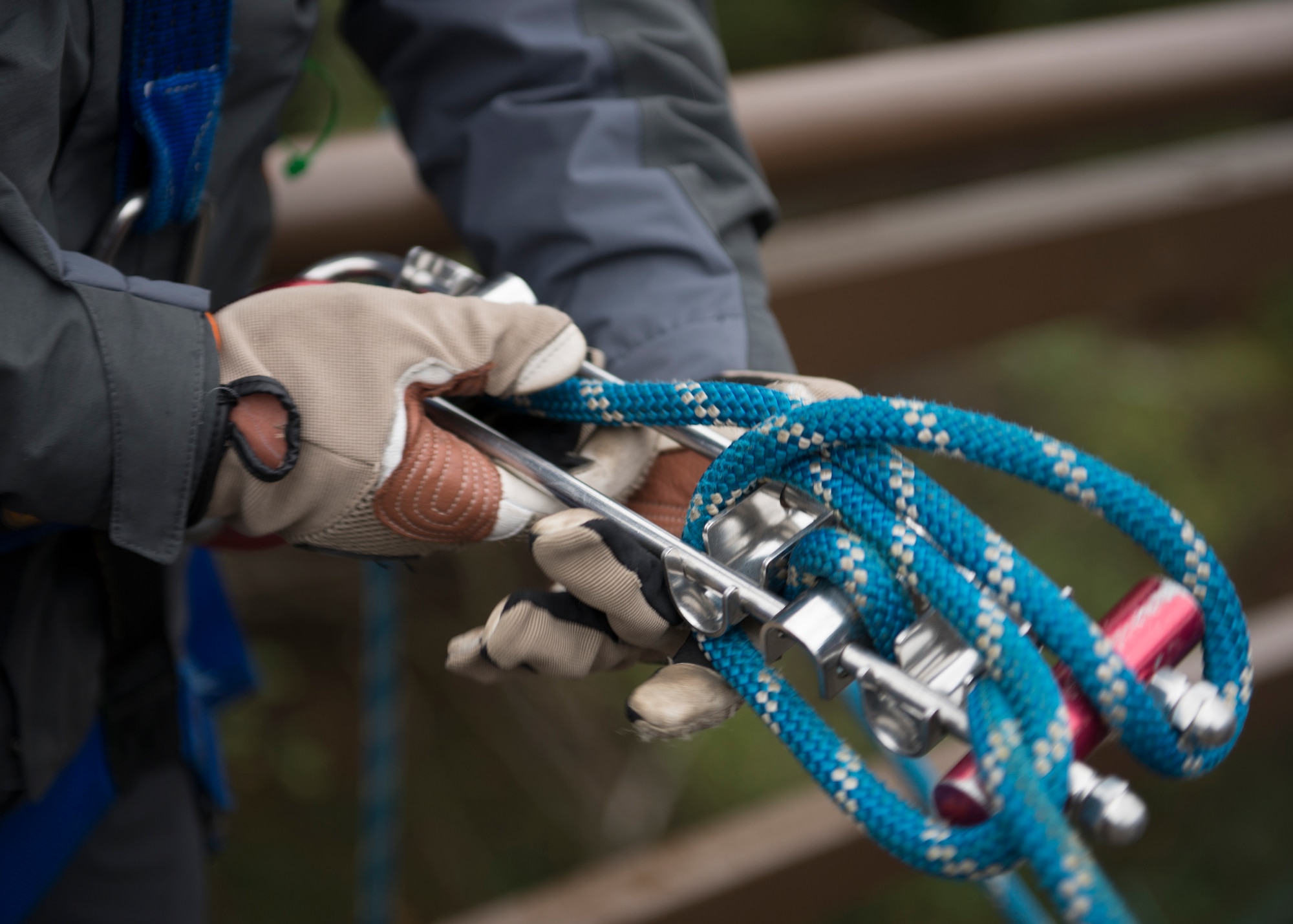 Samuel Burns, a firefighter from the 422nd Civil Engineer Squadron, wraps knots on a brake bar rack during Rescue Technician I Course near Ramstein Air Base, Germany, Oct. 10, 2019. Multiple knots on the brake bar rack are necessary to add friction to the system, making it easier for firefighters to control the system’s ascent and descent.