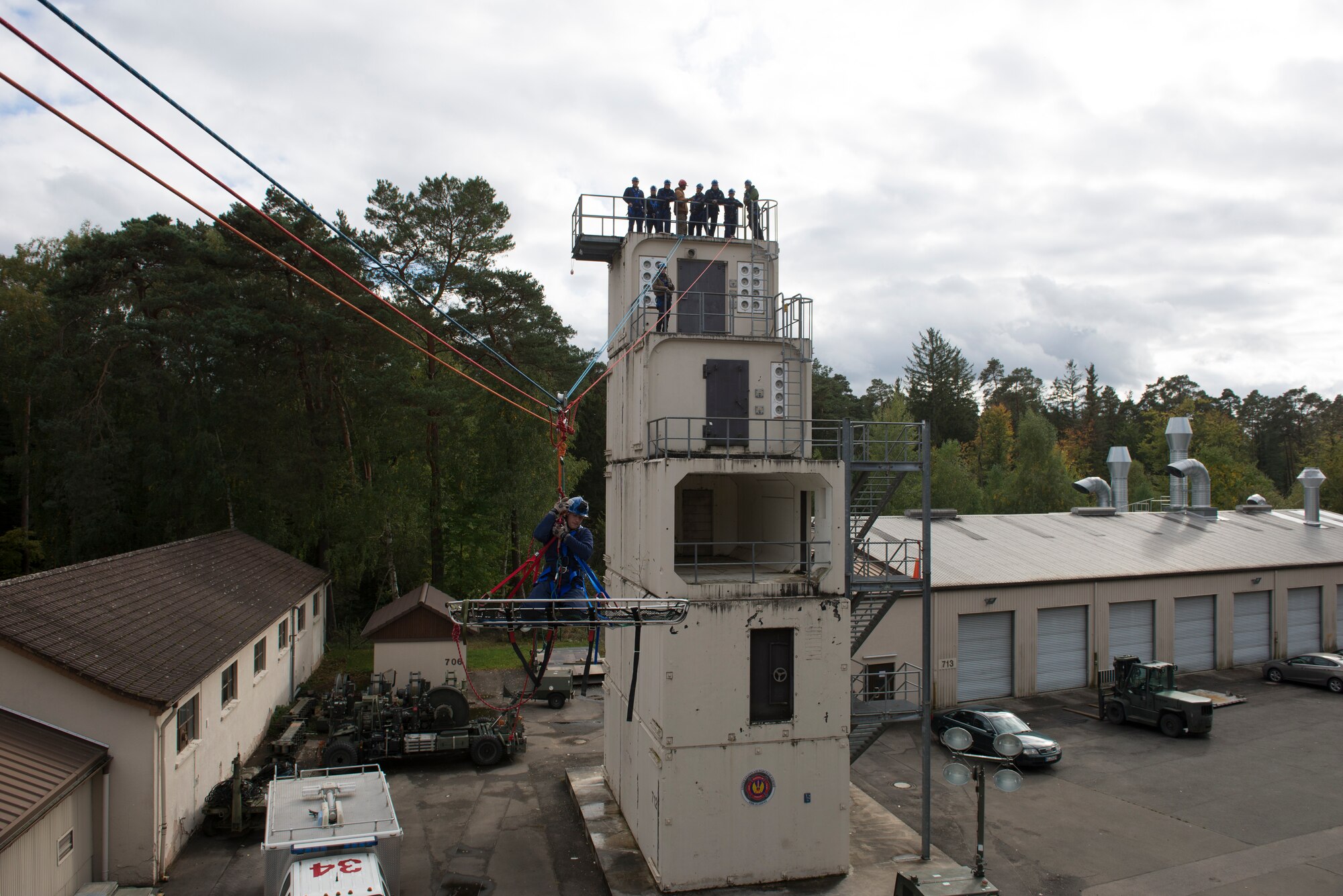 Airman 1st Class Trevor Farber, a firefighter from the 86th Civil Engineer Squadron, sits suspended in the air during Rescue Technician I Course near Ramstein Air Base, Germany, Oct. 10, 2019. This maneuver, called the “highline”, requires firefighters to split up into two teams to transport one or more persons across different buildings.