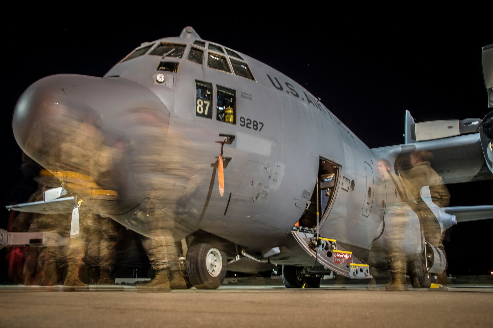 Photo of Airmen preparing a C-130 for flight.
