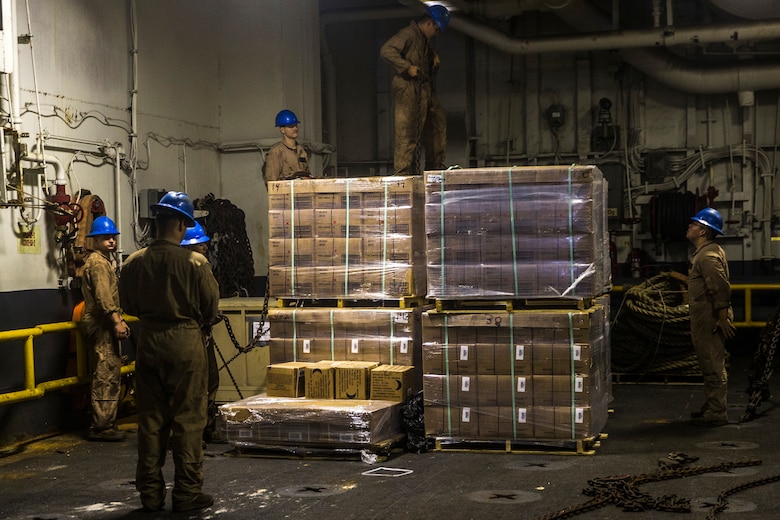U.S. Marines with the 26th Marine Expeditionary Unit move and secure cargo aboard the amphibious assault ship USS Bataan (LHD 5) during composite training unit exercise in the Atlantic Ocean Oct. 9, 2019. Combat cargo Marines are key members of the team that ensure all gear and equipment is loaded safely and efficiently. (U.S. Marine Corps photo by Cpl. Tanner Seims)