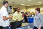 Arman Johnson speaks with a local business representative during a spouse employment job fair at the Airmen and Family Readiness Center, Edwards Air Force Base, California, Sept. 13.