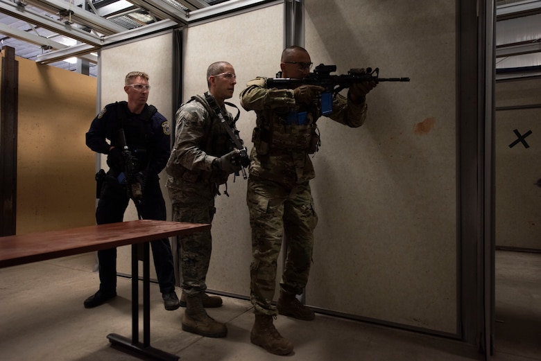 SCHRIEVER AIR FORCE BASE, Colo. —  Ryan Shearn, left, 50th Security Force Squadron, civilian police officer, Nicolas Ariba, center, 50th SFS response force member, Staff Sgt. Steven Miller, right, 50th SFS response force member, check and clear a room during an active shooter training scenario at the 50th SFS training facility, Schriever Air Force Base, Colorado, Oct. 9, 2019. The training exercise was conducted in partnership with the Fountain Police Department Rapid Response Team to bolster the communication and partnership between the two agencies. (U.S. Air Force photo by Staff Sgt. Matthew Coleman-Foster)
