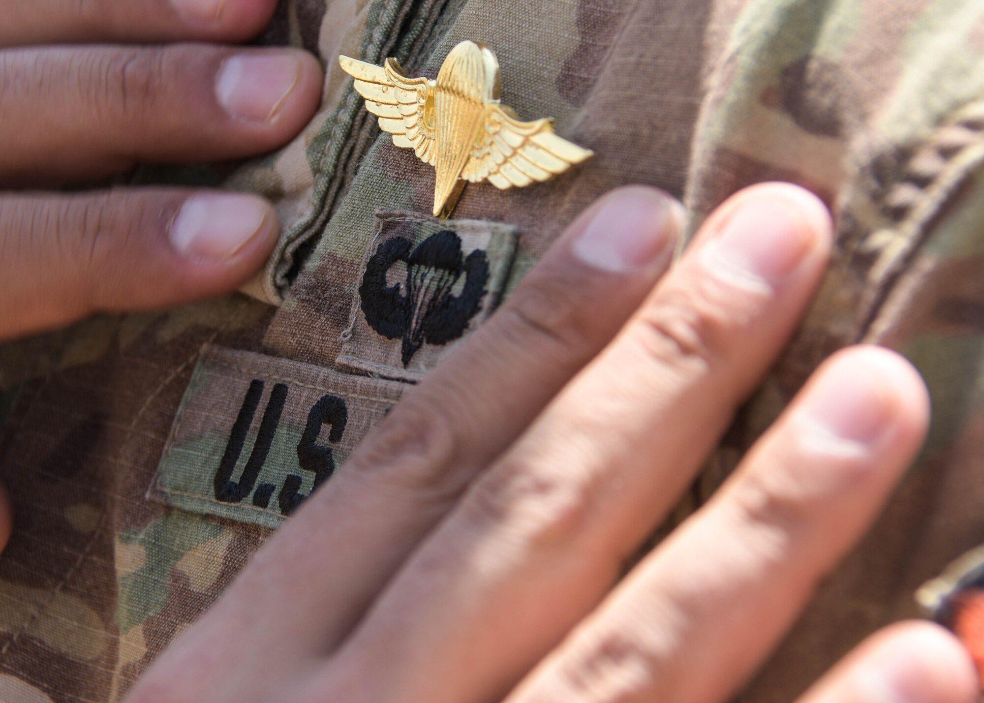 A U.S. service member gets jump wings pinned on for his participation in the Friendship Jump during Exercise Eager Lion on Sept. 5, 2019.