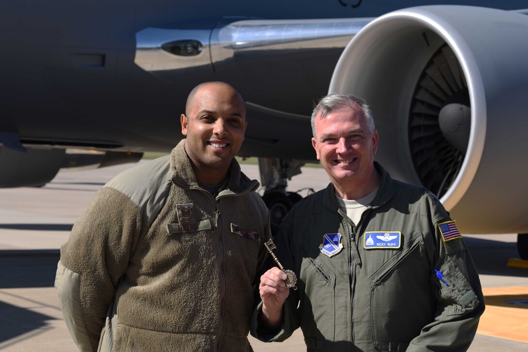 Tech. Sgt. Leonard Owens, 22nd Aircraft Maintenance Squadron guidance and control craftsman, presents the key of the aircraft to Maj. Gen. Ricky N. Rupp, Air Force District of Washington commander, Oct. 11, 2019, at McConnell Air Force Base, Kan. McConnell has now received 15 KC-46A Pegasus to the base. (U.S. Air Force photo by Airman 1st Class Marc A. Garcia)