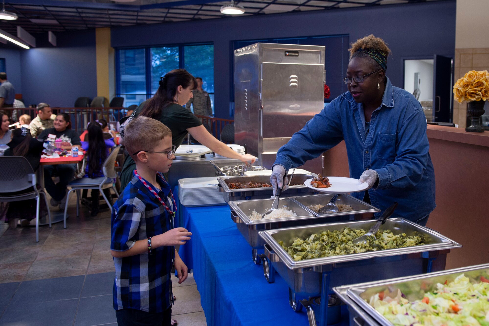 Sharon Register, 23d Force Support Squadron community readiness consultant, serves food during a Deployed Spouses Dinner Oct. 15, 2019, at Moody Air Force Base, Ga. The monthly event is a free dinner at Georgia Pines Dining Facility designed as a ‘thank you’ for each family’s support and sacrifice. The dinner, occurring on every third Tuesday of the month, provides an opportunity for spouses to interact with other families of deployed Airmen, key spouses and unit leadership as well as provide a break for the spouse while their military sponsor is deployed. The next Deployed Spouses Dinner will be Nov. 19. (U.S. Air Force photo by Airman Azaria E. Foster)