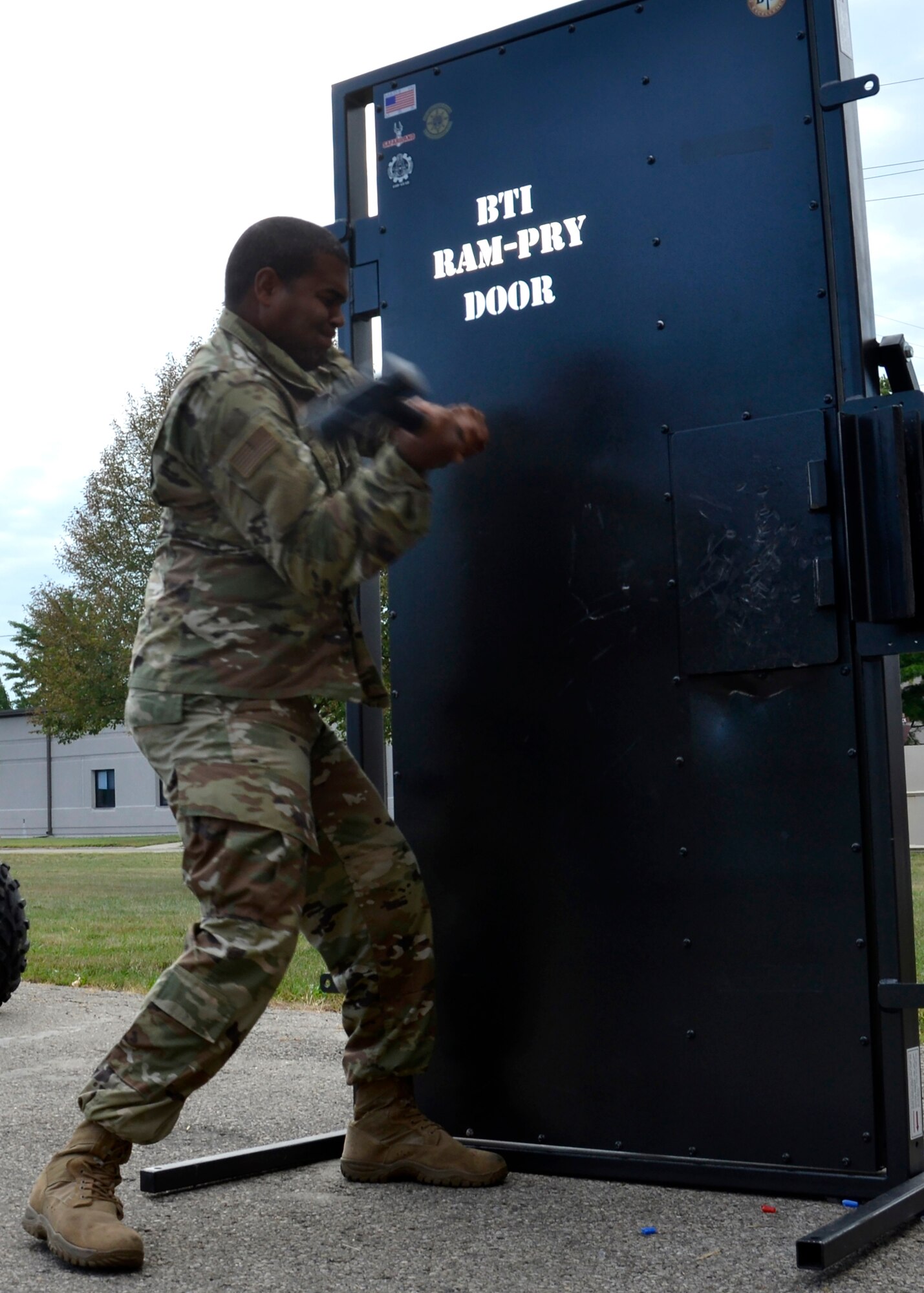 Staff Sgt. Andrew Swasey, fire team member, 445th Security Forces Squadron, swings a sledgehammer to force open a metal training door on September 8, 2019. About 30 Airmen from the squadron learned how to use three types of tools during door breach training at Wright-Patterson Air Force Base. (U.S. Air Force photo/1st Lt. Rachel Ingram)