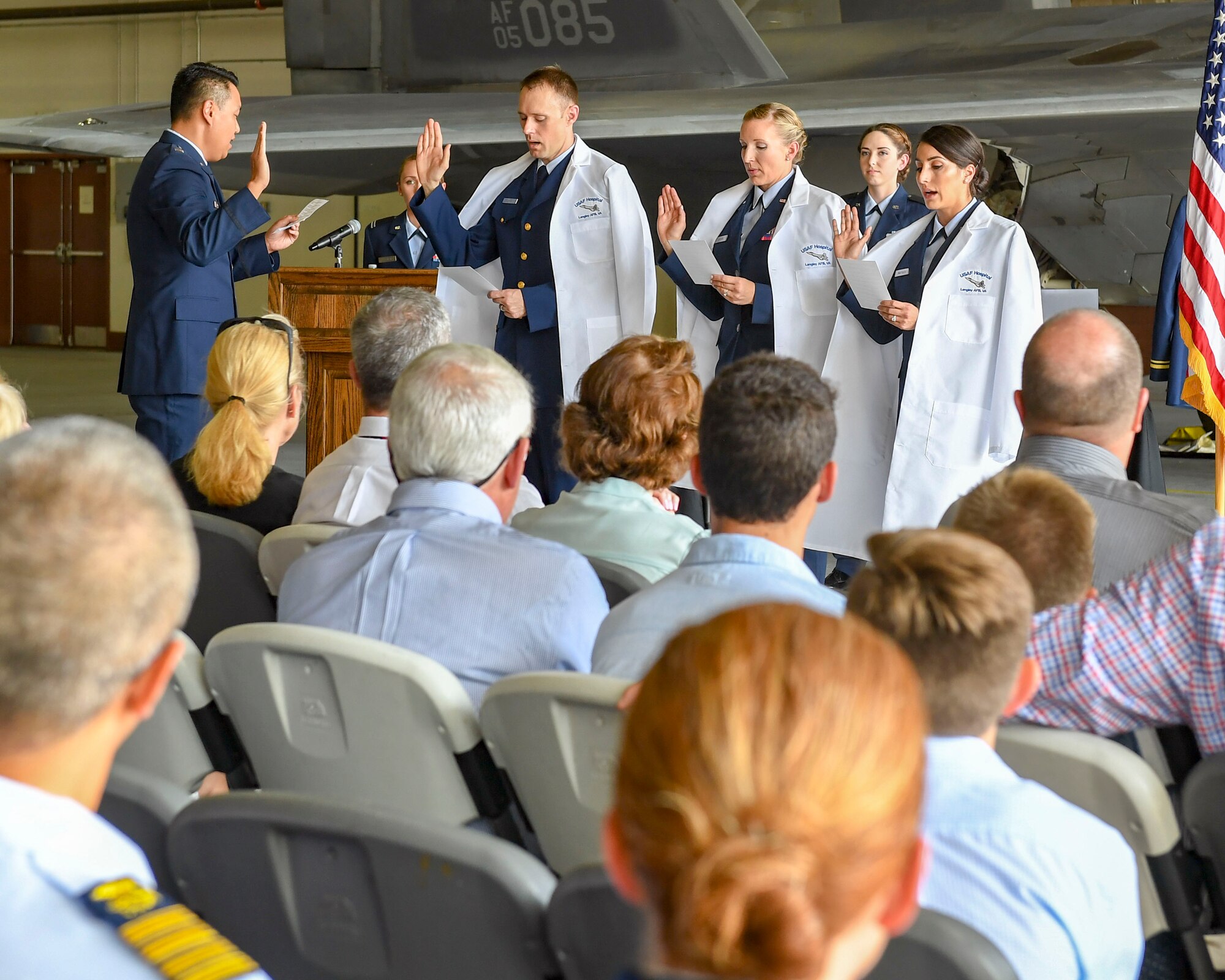 Three graduates of the Interservice Physician Assistant Program take a professional oath at Joint Base Langley-Eustis, Virginia, Oct. 3, 2019.
