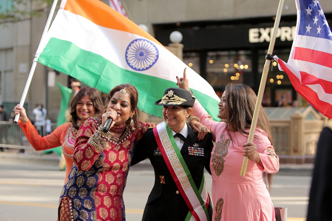 Volunteer dancers from left to right: Minal Desal, Skokie Park District Commissioner; Mona Bhalla, an internationally known Bollywood singer and local Chicago celebrity; and Bratashree Roy Biswas, with the Chicago Asian Network, perform the traditional Bollywood and Punjabi style of Indian dancing with Brig. Gen. Kris A. Belanger, Commanding General, 85th U.S. Army Reserve Support Command, during the 67th Annual Columbus Day Parade in the City of Chicago, October 14, 2019.