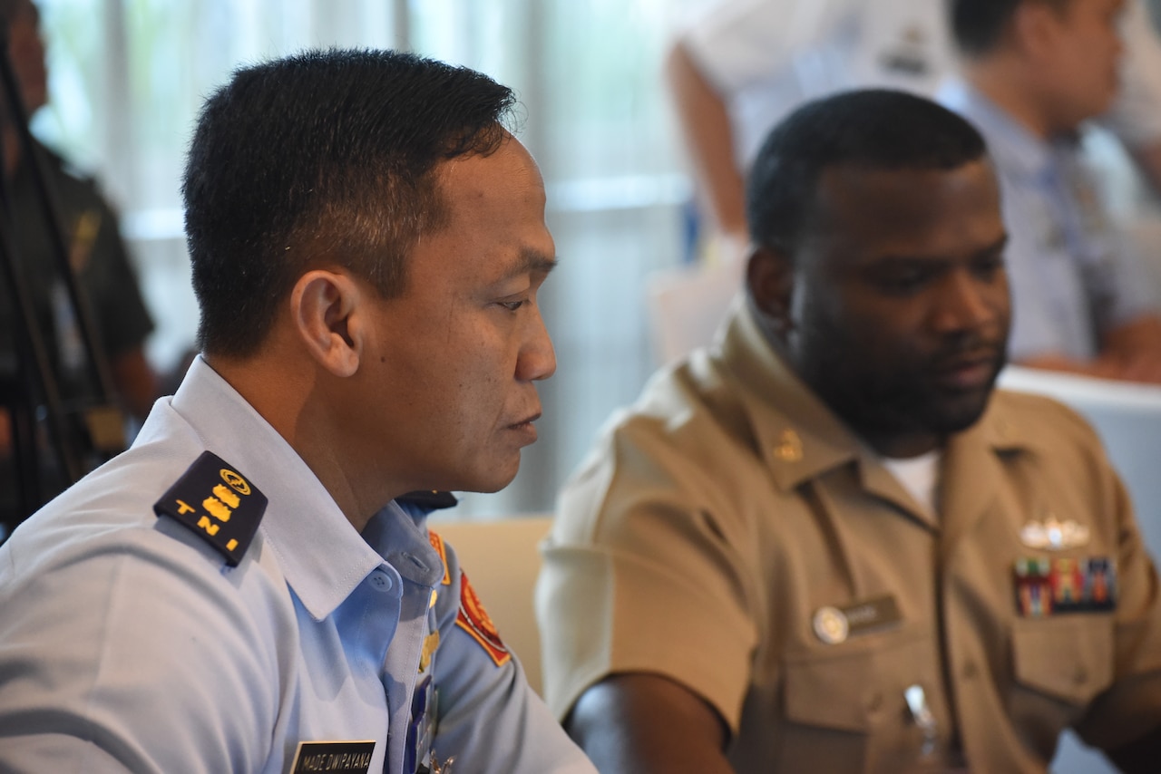 Indonesian officer and U.S. Navy chief petty officer participate in a cyber exercise.