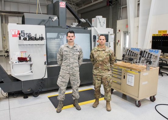 Staff Sgt. David Petrich and Tech. Sgt. Kevin Collins, 366th Maintenance Squadron, metal fabrication mechanics, pose for a photo Oct. 1, 2019, at Mountain Home Air Force Base, Idaho. Collins and Petrich cunstructed a spar repair item used to mend the leading edge wing of an F-15E Strike Eagle. (U.S. Air Force photo by Senior Airman Tyrell Hall)
