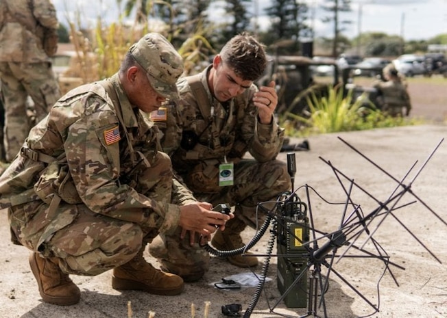 Army soldiers assigned to the 25th Infantry Division, Schofield Barracks, Hawaii, participate in a test of the Navy's Mobile User Objective System.