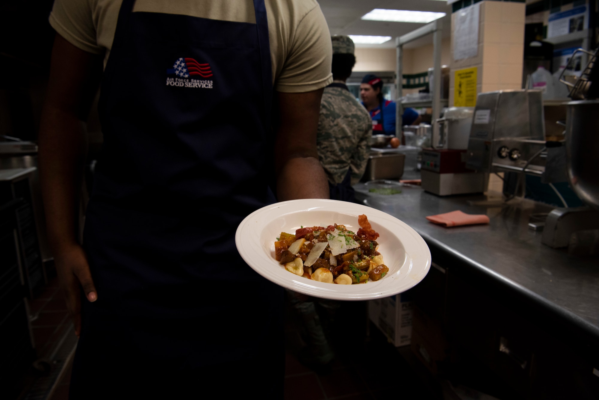 The final dish from Chop It Like It’s Hot is being presented at the end of a cooking competition Oct 15, 2019, at F.E. Warren Air Force Base, Wyo. The team plated pasta with lamb stew, topped with prosciutto. (U.S. Air Force photo by Senior Airman Abbigayle Williams)