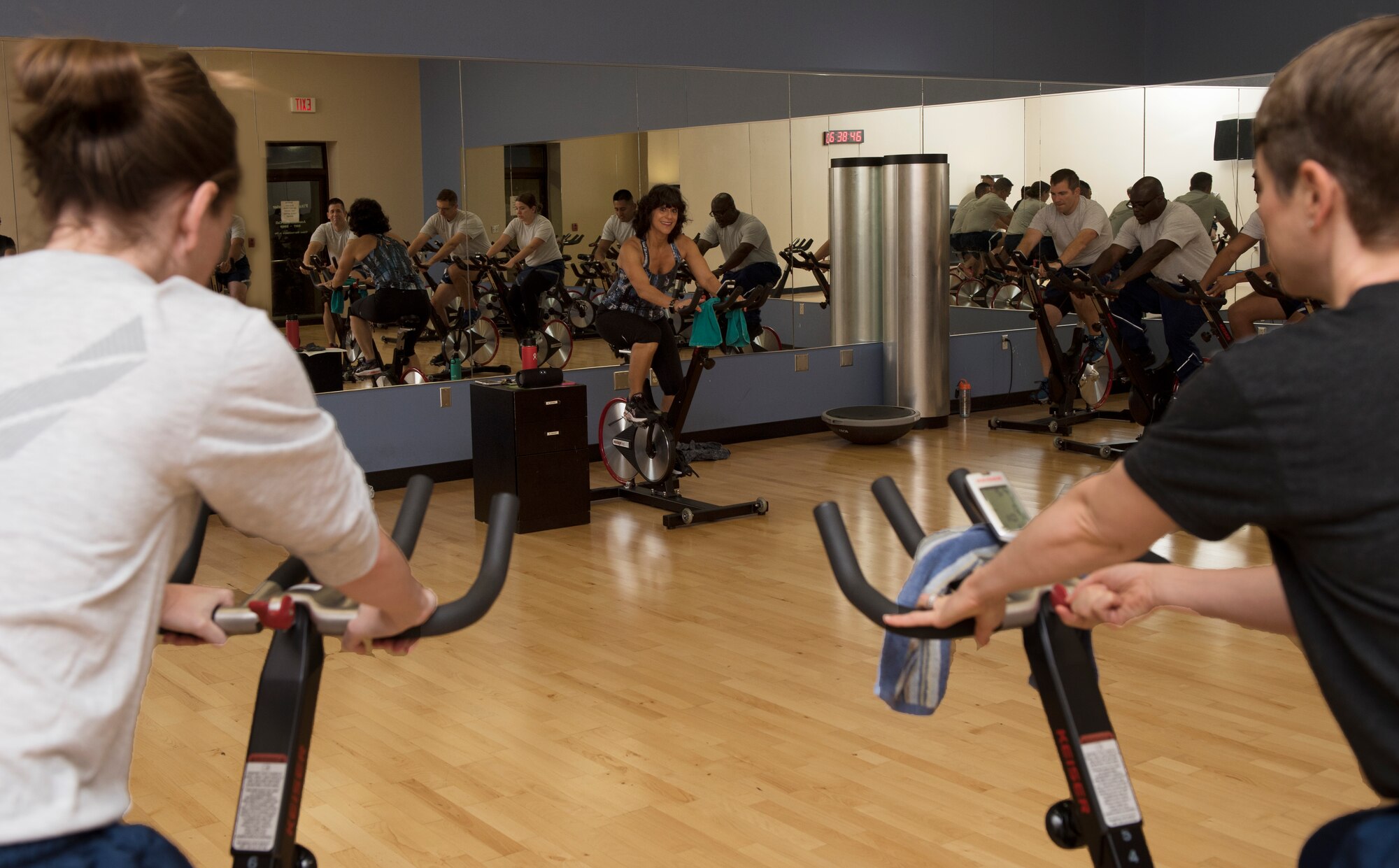 Alicia Ferris-Dannenberg, the health coordinator and registered nurse assigned to the 509th Medical Group, leads Airmen in a cycling class on October 10, 2019, at Whiteman Air Force Base, Missouri. The class served as part of the Health and Readiness Optimization (HeRO) strategy, an initiative newly adopted by the Air Force to address targets for health improvements in areas such as physical activity, nutrition, sleep and nicotine cessation. (U.S. Air Force photo by Staff Sgt. Kayla White)
