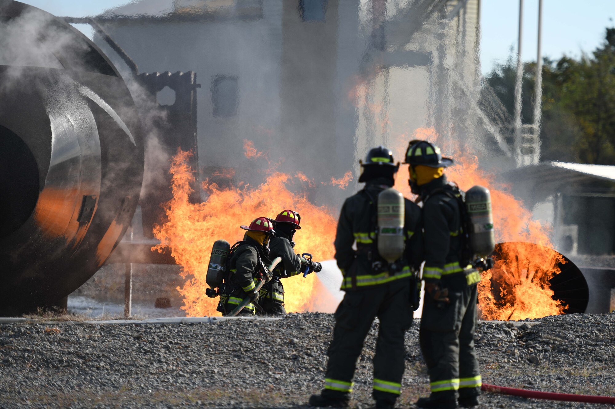 Men put out a fire.