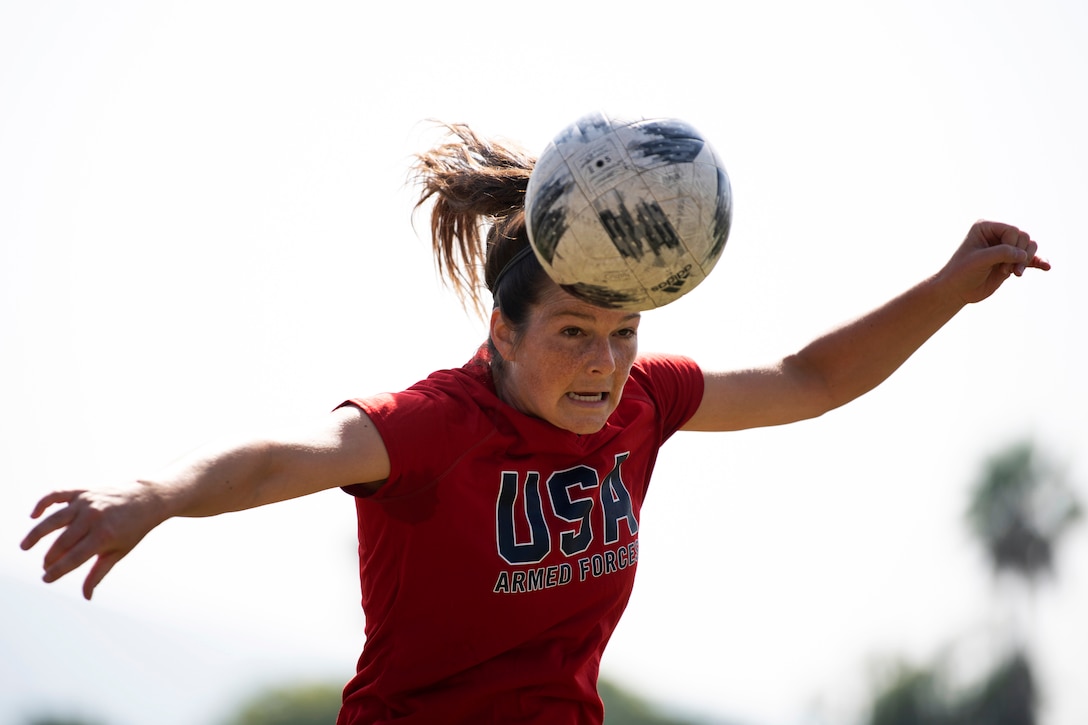 An Air Force athlete heads a ball.