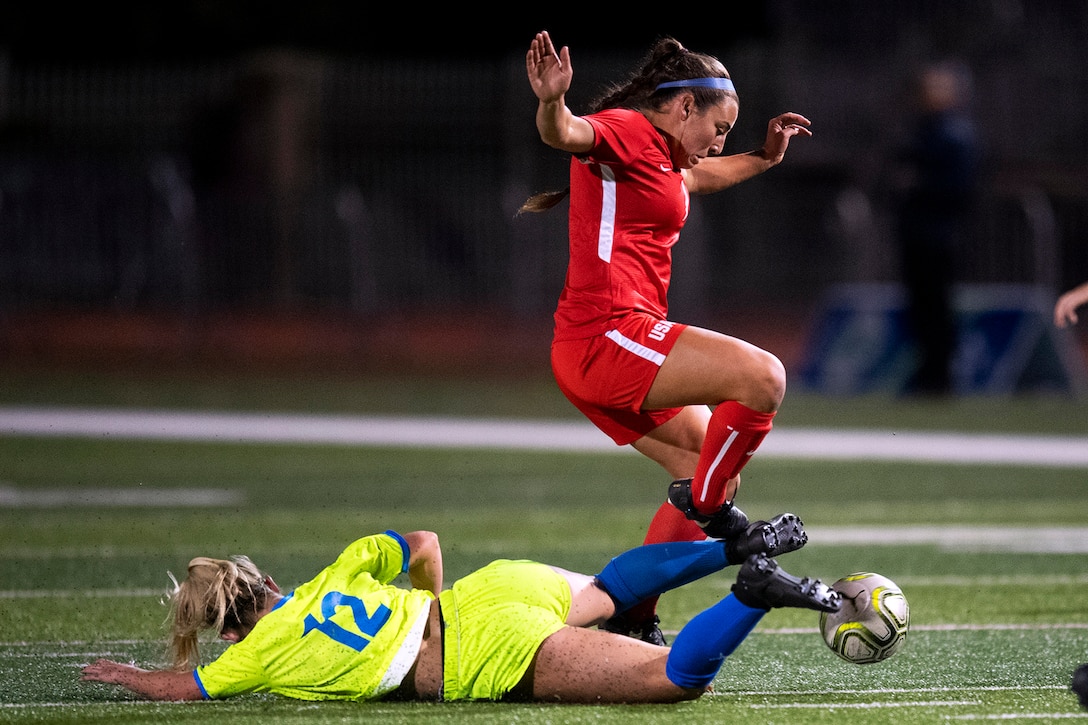 Air Force 2nd Lt. Kaitlyn Cook, right, of the Women’s Armed Forces Soccer Team evades a slide tackle during a scrimmage match against a women’s soccer club in San Juan Capistrano, Calif., Oct. 9, 2019.