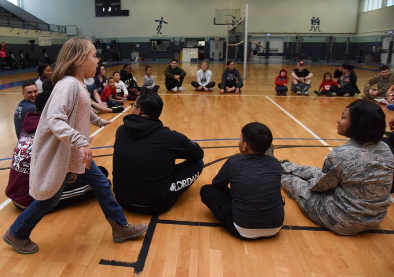 U.S. Airmen play duck, duck, goose with special needs children at Vogelweh Military Complex, Germany, Oct. 9, 2019. On the second Wednesday of every month during the school year, active duty members gather at the Vogelweh Fitness Center to play with special needs children of DoD service members for fun and physical fitness.