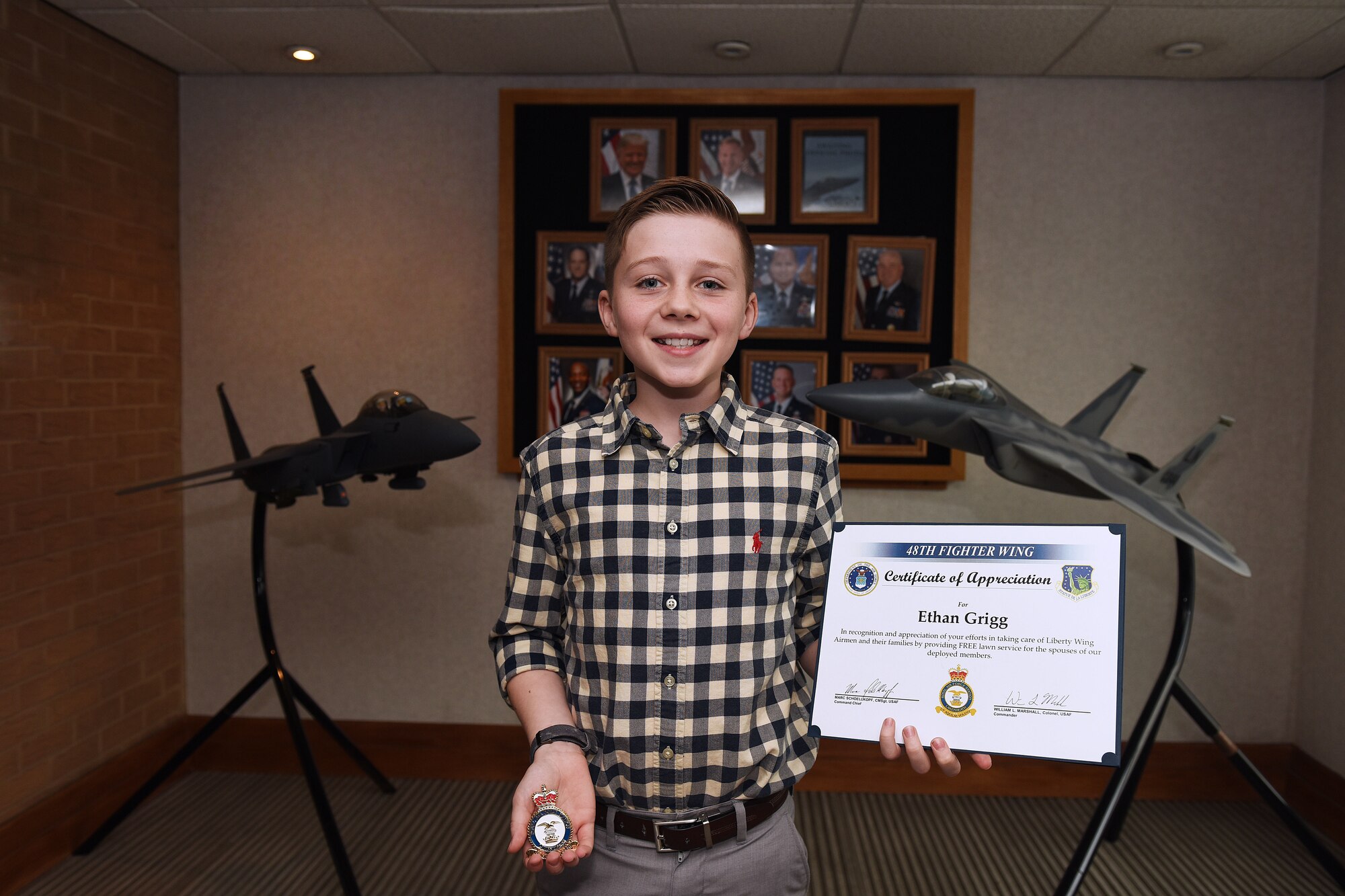 Ethan Grigg, son of U.S. Air Force Master Sgt. Daniel Grigg, 748th Aircraft Maintenance Squadron weapons section chief, poses for a photo after his recognition ceremony at Royal Air Force Lakenheath, England, Oct. 15, 2019. Ethan was recognized for offering free yard trimming for deployed families across the Liberty Wing. (U.S. Air Force photo by Senior Airman Shanice Williams-Jones)