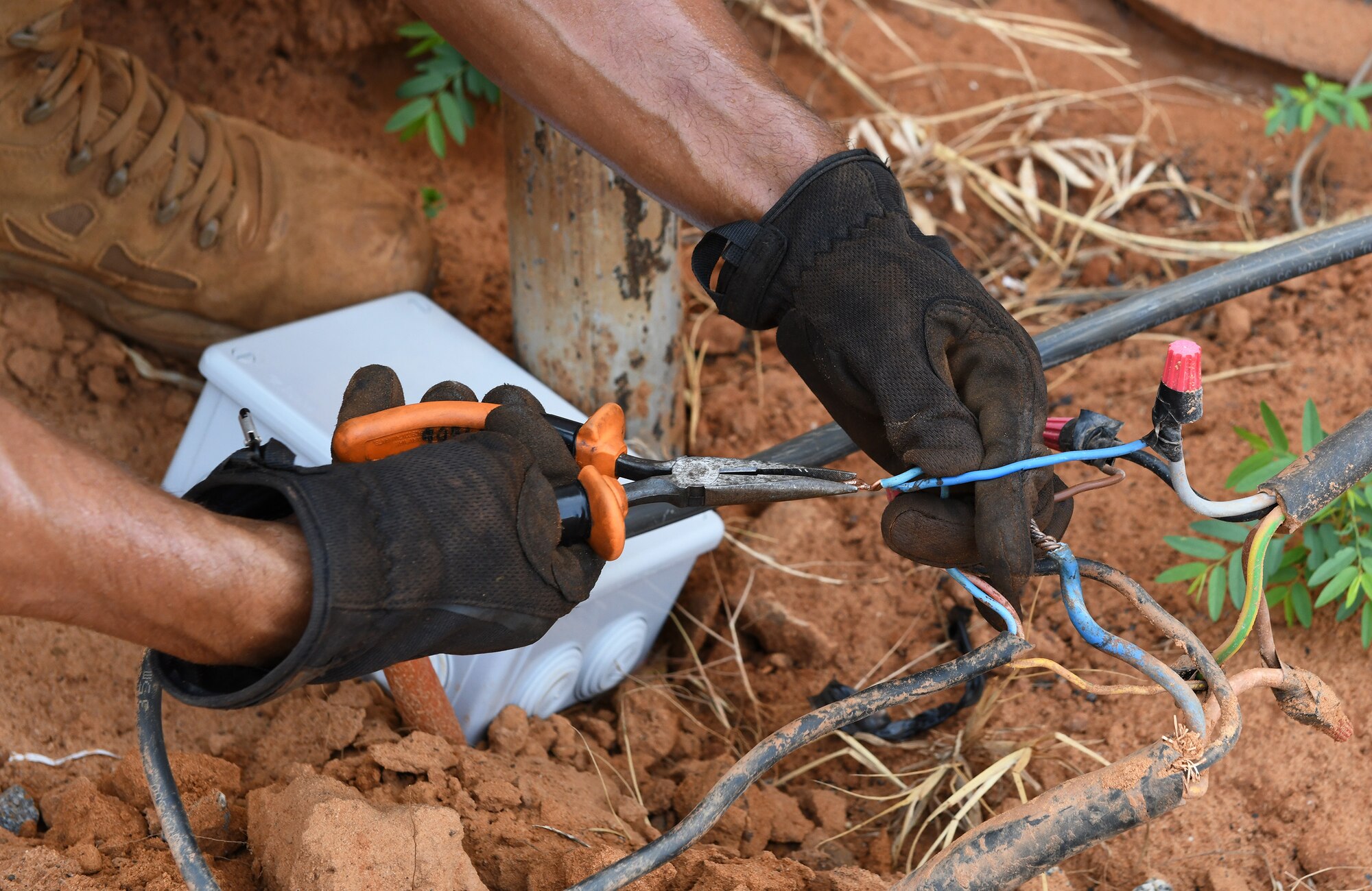 U.S. Air Force Tech. Sgt. Guillermo Cajigas, 768th Expeditionary Air Base Squadron Power Production and Electrical Systems section lead, connects a new cable for perimeter lighting at Nigerien Air Base 101, Niamey, Niger, Oct. 10, 2019. Civil Engineer Airmen are continually upgrading the base’s infrastructure, improving its security, facilities and personnel’s quality of life. (U.S. Air Force photo by Staff Sgt. Alex Fox Echols III)