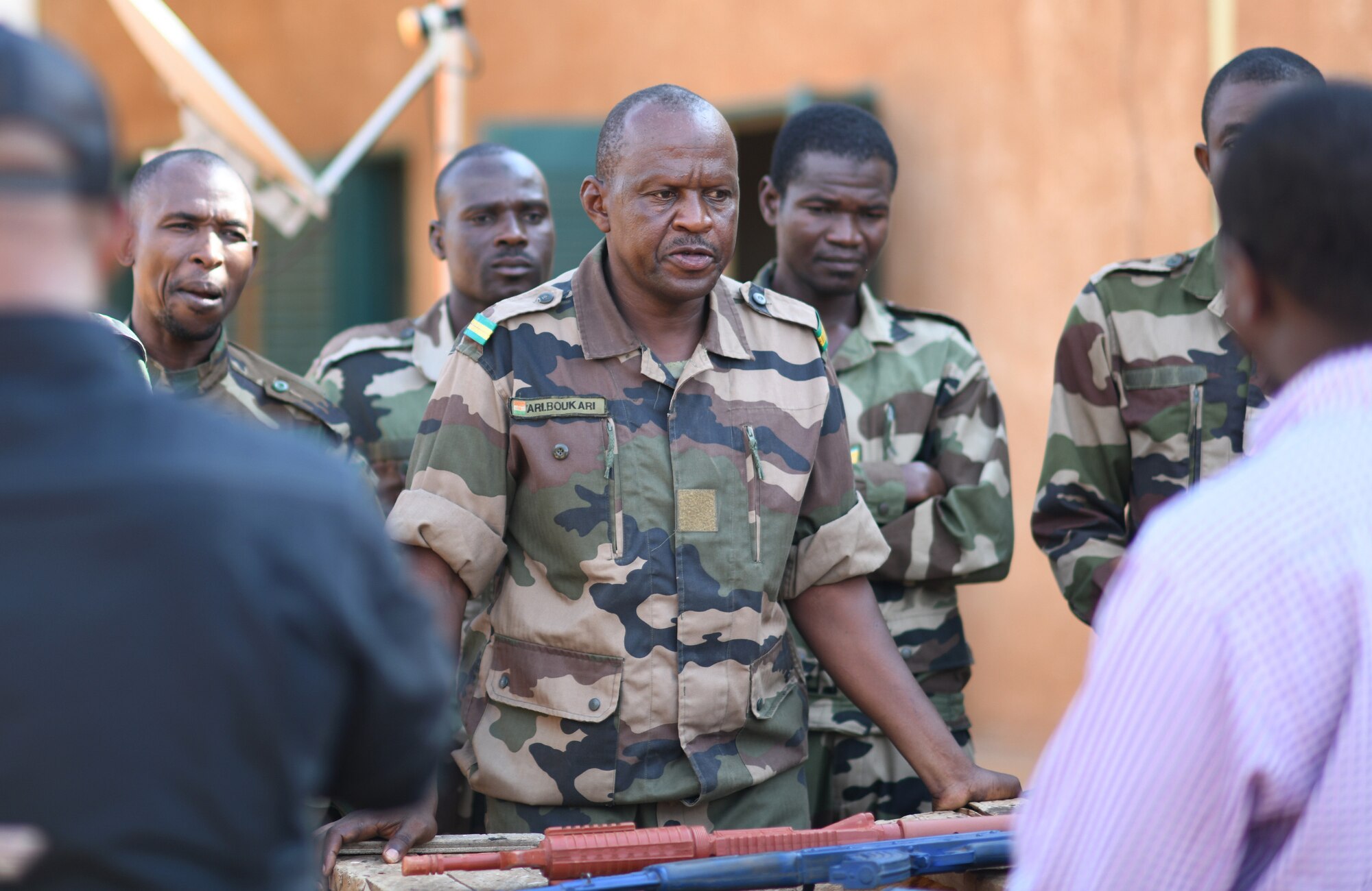 A Forces Armées Nigeriennes (Nigerien Armed Forces) Genie Unit member speaks to instructors during an Improvised Explosive Device Awareness Course in Niamey, Niger, Oct. 11, 2019. During the week-long course, the 768th Expeditionary Air Base Squadron Explosive Ordnance Disposal team and Security Forces Air Advisors taught FAN personnel valuable skills for the deployed environment such as how to locate and react to an IED, how set up a cordon and the procedures to clear the area. (U.S. Air Force photo by Staff Sgt. Alex Fox Echols III)