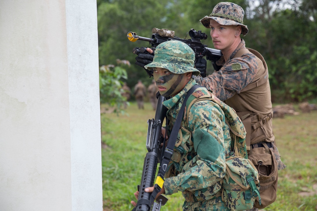 191007-M-QS181-1021 PENANJONG, BRUNEI (Oct. 7, 2019) U.S. Marines with India Company, Battalion Landing Team 3/5, 11th Marine Expeditionary Unit (MEU) and soldiers with the Royal Brunei Armed Forces set security after reaching an objective point. Elements of the 11th MEU are ashore in Brunei to perform day and night training in an urban environment and to enhance interoperability and partnership between the U.S. and Brunei during Combined Afloat Readiness and Training - Brunei 2019. (U.S. Marine Corps photo by Cpl. Jason Monty)