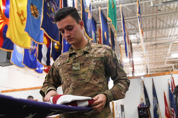 Airman 1st Class Adam Worley, 22nd Operations Support Squadron Radar, Airlift and Weather Systems technician, carefully folds the flag during honor guard training Oct. 8, 2019, at McConnell Air Force Base, Kan.  Airmen train for two weeks before serving four months as base honor guard members. The team currently provides services in 77 counties across Kansas and northern Oklahoma. (U.S. Air Force photo by Airman 1st Class Nilsa E. Garcia)