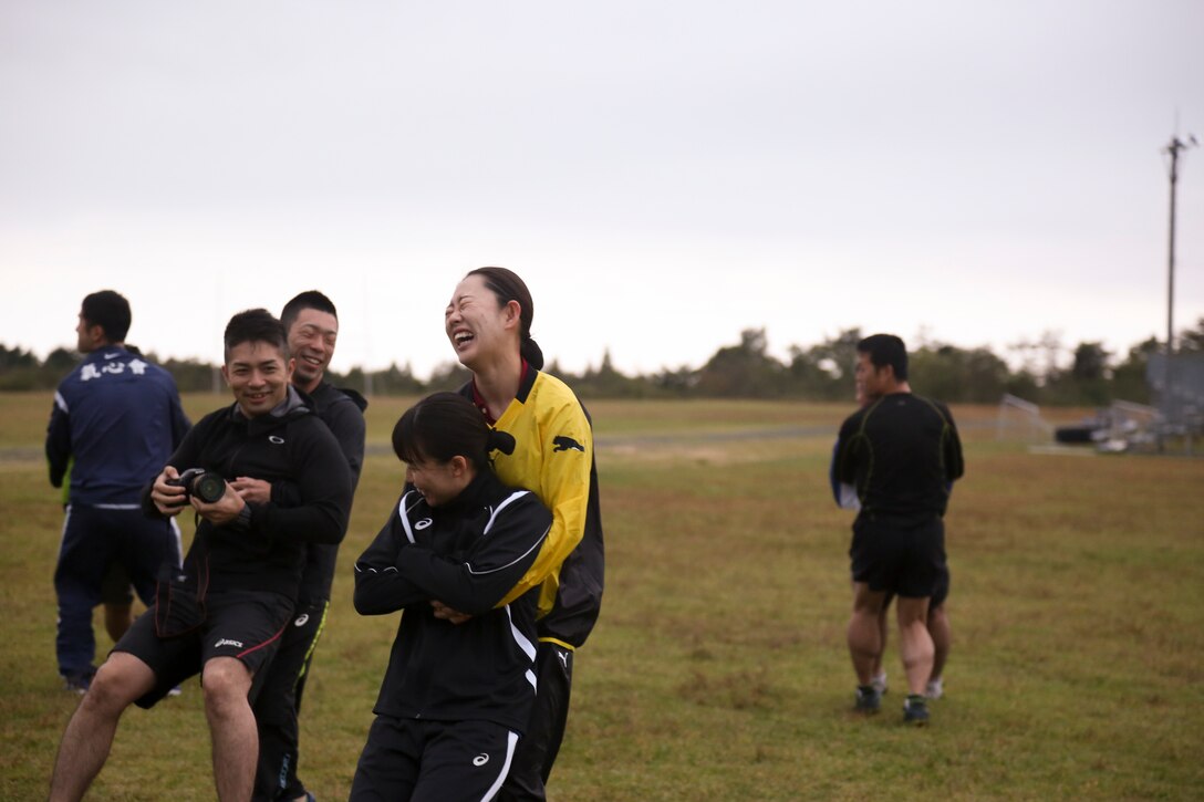 Members of the Japan Ground Self-Defense Force buddy drag during physical training on Combined Arms Training Center Camp Fuji, Gotemba, Japan, Oct. 17, 2019. The JGSDF toured the base to learn operations of U.S. Marines, practice speaking English, and to strengthen the relationship between two nations.