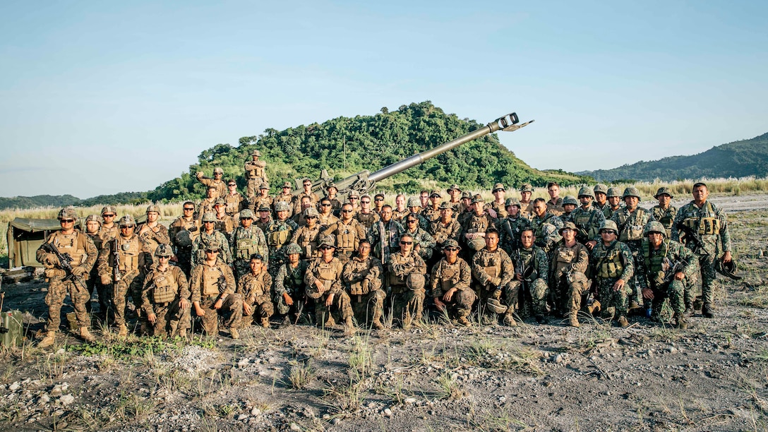 U.S. Marines with Alpha Battery, Battalion Landing Team 3/5, 11th Marine Expeditionary Unit, and Philippine Marines with the 17th Marine Corps Field Artillery Battalion, pose for a group photo at Colonel Ernesto Ravina Air Base, Philippines, during exercise KAMANDAG 3, Oct. 13, 2019. KAMANDAG helps participating forces maintain a high level of readiness and responsiveness, and enhances combined military-to-military relations, interoperability, and multinational coordination. (U.S. Marine Corps photo by Staff Sgt. Donald Holbert)