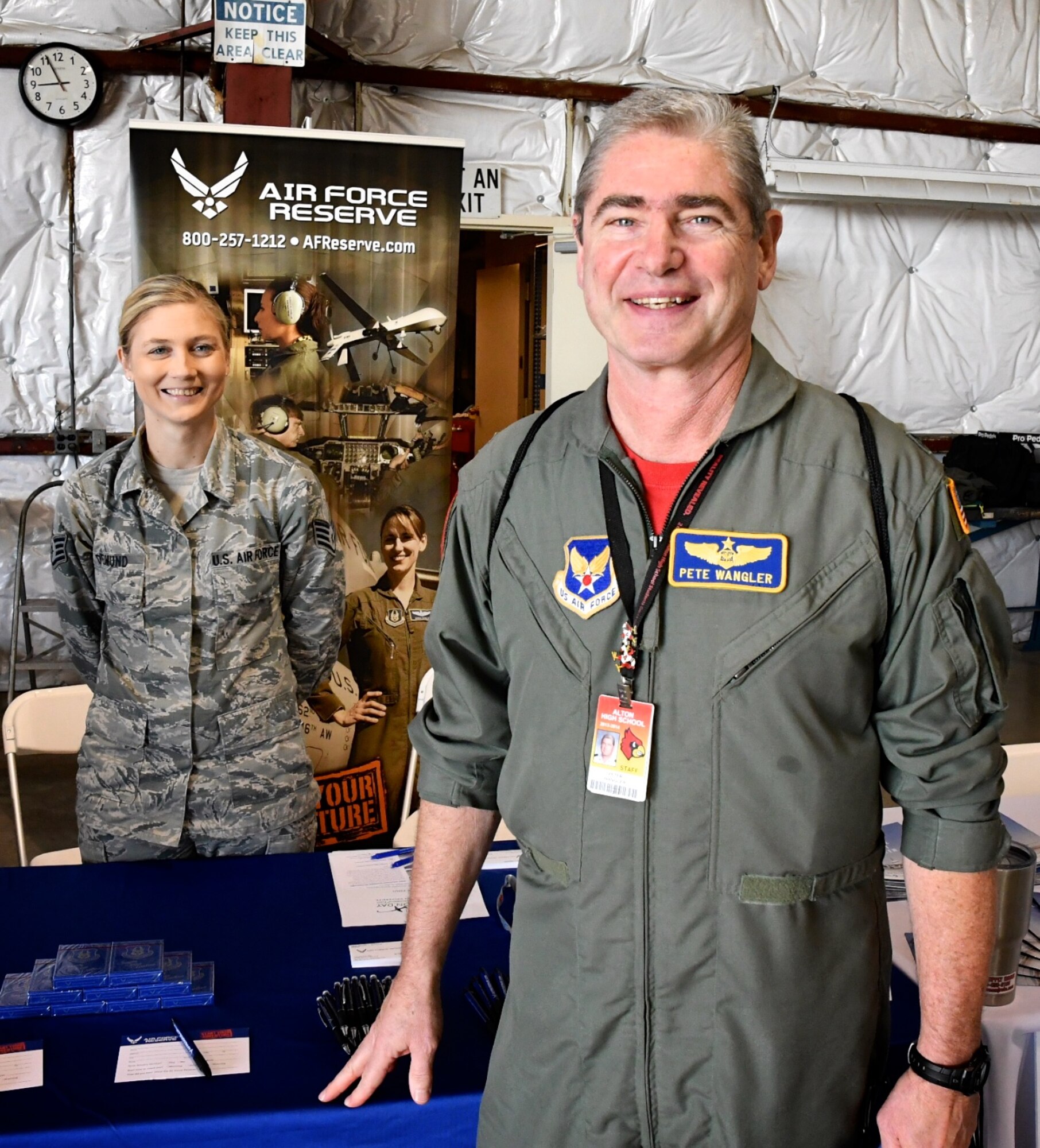 Staff Sgt. Jennifer Deimund, 932nd Airlift Wing recruiter, meets Col. Pete Wangler, commander of the Alton JROTC High School program.  Various current and retired members of the 932nd Airlift Wing were on hand to speak about their military experience and Air Force Reserve openings at a Girls in Aviation event held at the St. Louis Downtown Airport Oct. 4, 2019.  Col. Wangler and his cadets have been involved with the reserve unit over several years.  (U.S. Air Force photo by Lt. Col. Stan Paregien)