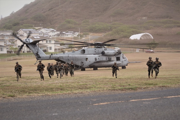 U.S. Marines with Charlie Company, 1st Battalion, 3rd Marine Regiment, conduct a simulated air assault on Landing Zone Eagle from a CH-53E Super Stallion with Heavy Marine Helicopter Squadron 463, part of exercise Island Marauder on Marine Corps Base Hawaii, Kaneohe Bay, Sept. 25, 2019. The Island Marauder exercise is a training event during which Marines conducted different scenarios while testing new technology on the battlefield. (U.S. Marine Corps photo by Ashley Calingo)