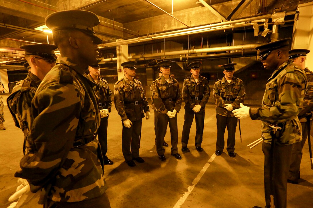 Marines with Marine Barracks Washington D.C. listen to an instructor during Ceremonial Drill School at Marine Barracks Washington, D.C., Oct. 16, 2019. Each year, the Marines spend countless hours perfecting Barracks drill fundamentals in preparation for upcoming ceremonial commitments. (U.S. Marine Corps photo by Lance Cpl. Allen Sanders)