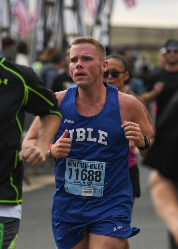 U.S. Army Sgt. 1st Class Nick Krause, Alpha Company, 2nd Battalion, 210th Aviation Regiment, 128th Aviation Brigade CH-47 helicopter repairer instructor writer, approaches the finish line at the 35th annual Army Ten-Miler race in Washington D.C., Oct. 13, 2019.