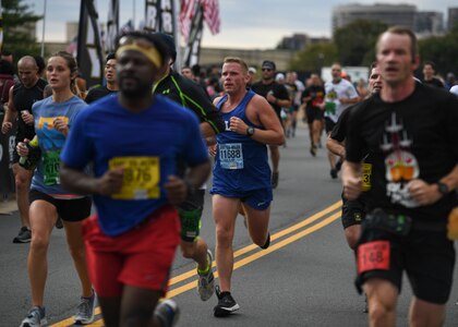 U.S. Army Sgt. 1st Class Nick Krause, Alpha Company, 2nd Battalion, 210th Aviation Regiment, 128th Aviation Brigade CH-47 helicopter repairer instructor writer, runs during the 35th annual Army Ten-Miler race in Washington D.C., Oct. 13, 2019.